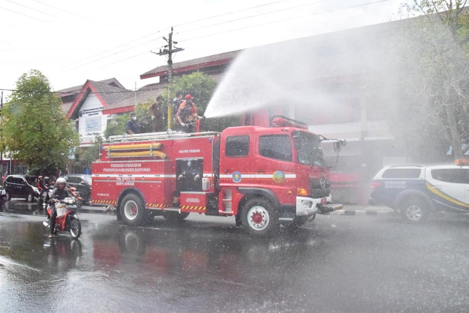 DESINFEKTAN : Mobil damkar dikerahkan untuk menyemprotkan desinfektan sepanjang jalan protokol di Kota Purwokerto.